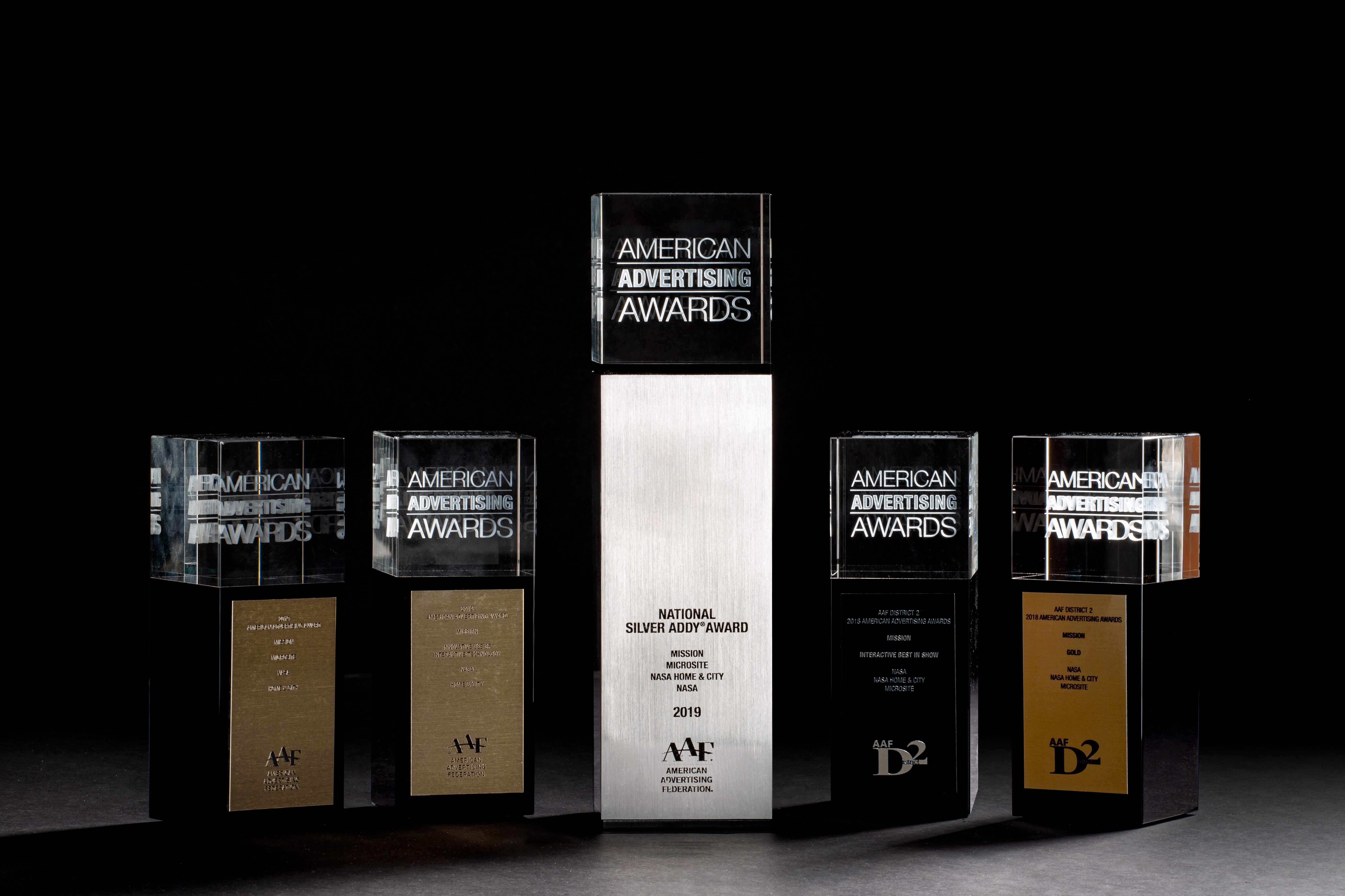 five american advertising awards in front of a black background