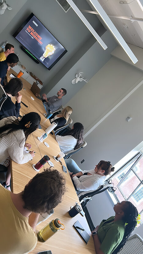 Mission Interns attend a welcome meeting with staff on their first day