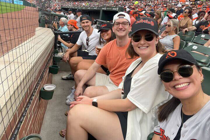 Several Mission employees watching the game from behind home plate