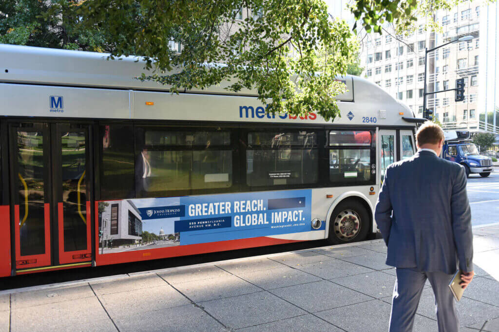 A D.C. city bus with an advertisement on the side.