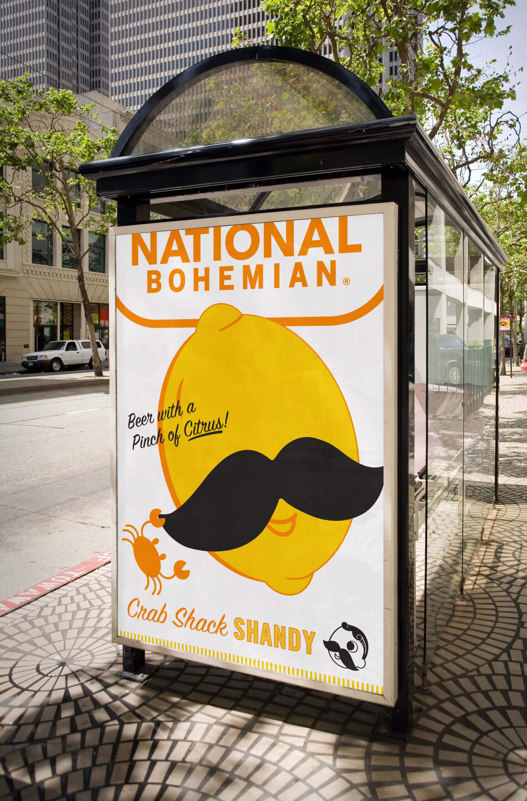 A mocked-up bus shelter advertisement for National Bohemian’s Crab Shack Shandy beer featuring a graphic of a lemon with the iconic “Natty Boh” mustache.
