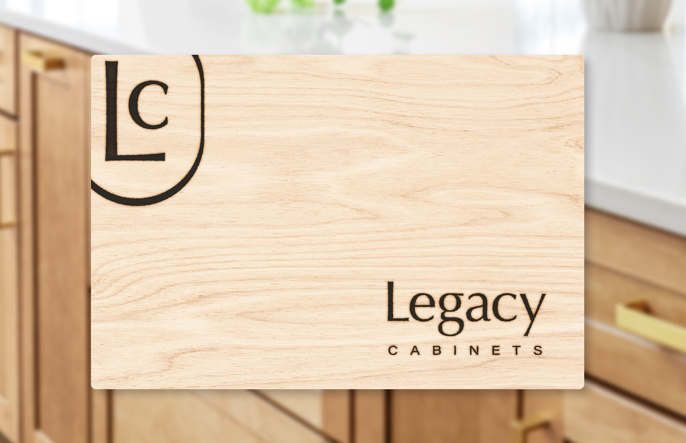 Legacy Cabinets logo and LC monogram branded onto a light wood surface, shown against a softly blurred cabinetry background.