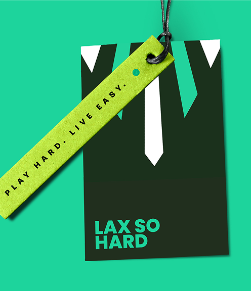 Branded clothing hangtag featuring a dark green card with the 'LAX SO HARD' logo and a textured lime green ribbon tag. Both are attached with a black cord against a bright teal background.
