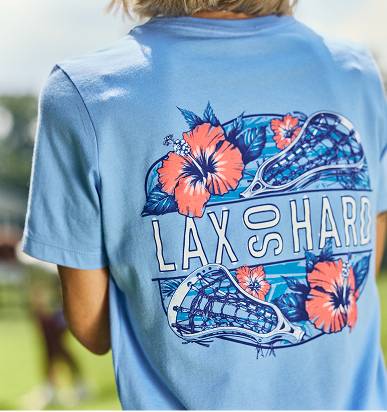 Back of a light blue T-shirt featuring a circular 'LAX SO HARD' graphic with orange hibiscus flowers and lacrosse sticks.